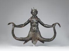 a bronze statue with an octopus around it's neck and hands in the shape of a woman