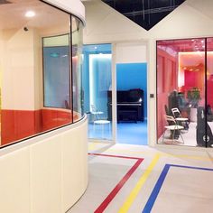 an office with colorful stripes on the floor and large glass doors leading to another room