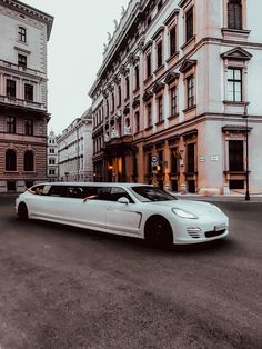 a white car is parked in front of some buildings