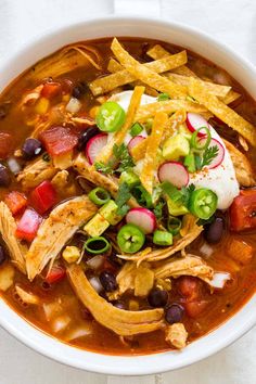 a white bowl filled with chicken tortilla soup