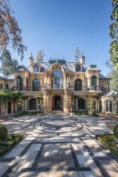 a large house with many windows and lots of trees