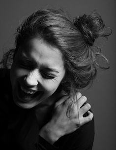 black and white photograph of a woman laughing