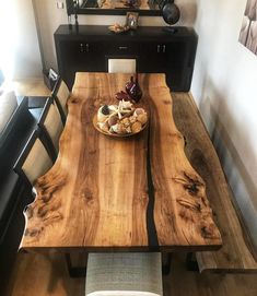 a wooden table with two chairs around it