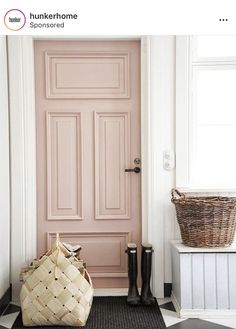 a black and white checkered floor with a pink door in the center, basket on the ground