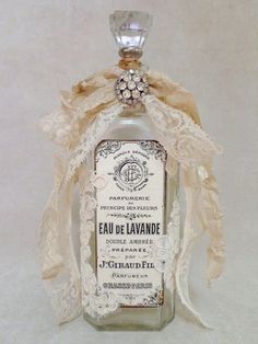 an old bottle with lace on it and a ribbon around the top that says eau de lavande