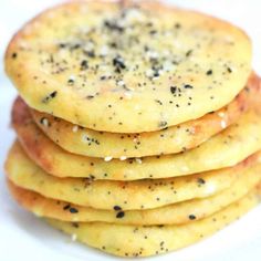 a stack of crackers sitting on top of a white plate covered in seasoning