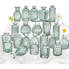 a collection of glass vases and jars