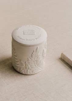 a small white container sitting on top of a table