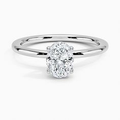 an oval cut diamond ring with a thin band