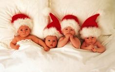 three baby babies wearing santa hats laying on top of a white blanket with the words, baby wish list lux bottle