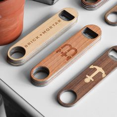 four wooden bottle openers sitting on top of a table