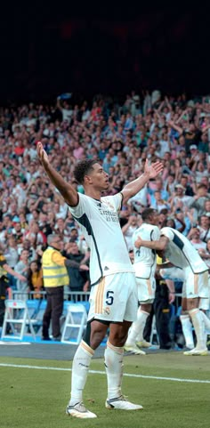 the soccer player is celebrating his team's victory over the opposing team in front of an audience