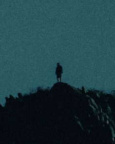 a person standing on top of a mountain at night