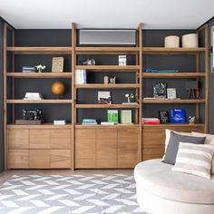 a living room filled with furniture and bookshelves