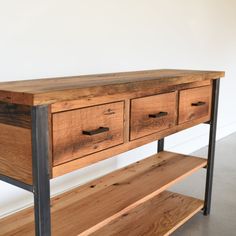 a wooden table with two drawers on one side and a metal shelf on the other