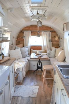 the interior of a tiny home with white walls and wood flooring, along with lots of natural light