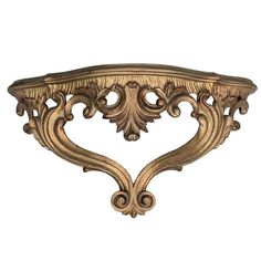 an ornate gold wall shelf on a white background