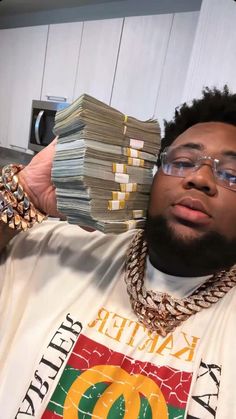 a man holding up stacks of money in front of his face