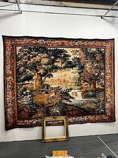 an old tapestry hanging on the wall in a room