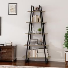 a tall wooden shelf with books on it in a living room next to a tv