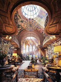 an ornately decorated library with chandeliers and bookshelves on the ceiling