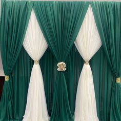 three green and white drapes with flowers on each side, one in the middle