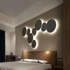 a bedroom with a large bed and round lights on the wall