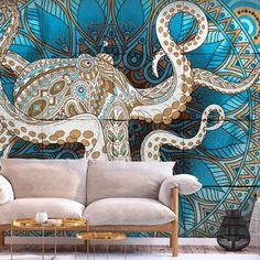 an octopus wall mural in a living room with white couches and blue patterned walls