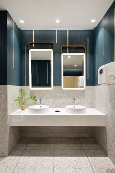 a bathroom with two sinks and mirrors in it