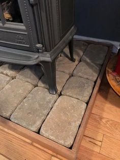 a wood stove sitting on top of a hard wood floor