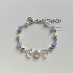 a bracelet with charms and pearls on it