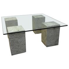 a glass table topped with cement blocks