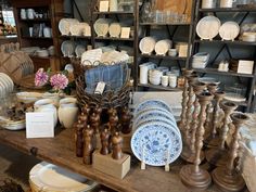 an assortment of dishes and plates on display in a store