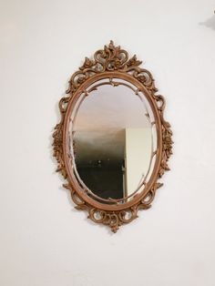 a mirror hanging on the side of a wall