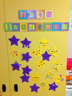 a bulletin board with purple stars and the word student on it in front of a yellow refrigerator