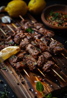 the skewers are being served with lemon wedges