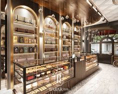 the interior of a pastry shop with gold trimmings and shelves filled with pastries