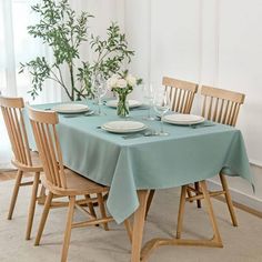 a dining room table set with place settings