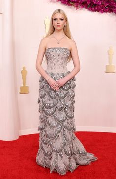 a woman in a strapless dress on the red carpet at an oscars event