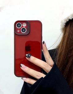 a woman is holding an iphone case with her fingernails and ring on it