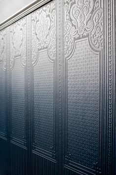 a close up of a metal door with intricate designs on the front and back panels