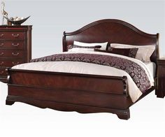 a wooden bed sitting next to a night stand with drawers on each side and a dresser in the middle