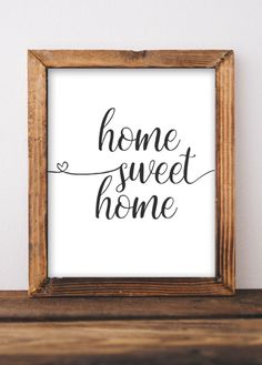 a wooden frame with the words home sweet home written in cursive writing on it