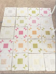 the quilt is laid out on the floor