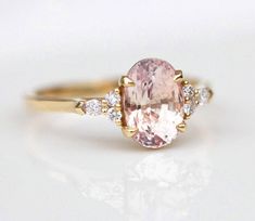 Best seller at Capucinne - Our Alessandra natural peach sapphire ring with side diamonds will captivate you in a heartbeat. With the prettiest blush peachy shade of the sapphire it compliments every skintone and brings a smile on the face Blush Sapphire Ring, Peach Sapphire Ring, Pink Saphire Engagement Ring, Engament Rings, Peach Sapphire Rings, Pink Sapphire Engagement Ring, Peach Sapphire Engagement Ring, Finger Art, Pink Sapphire Ring Engagement