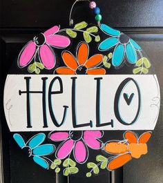 a door hanger with the word hello painted on it