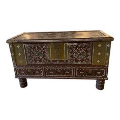 an old wooden chest with decorative designs on it