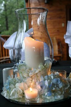 a table with candles and flowers on it