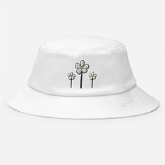 This bucket hat is a combination of timeless practicality and vintage style. Perfect for fishing, hiking, and 80s-90s nostalgia. Featuring 3 cartoon daisies for that extra nostalgic touch.  * 98% cotton, 2% spandex * Mid-profile hat with a high-profile embroidery area  * 3″ crown * Matching undervisor * Premium Flexfit sweatband * One size fits most * Head circumference: 21 ⅝″-23 ⅛″ (55 cm-58.7 cm) * Blank product sourced from Vietnam White Adjustable Retro Bucket Hat, Playful White Bucket Sun Hat, White Retro Bucket Hat, Adjustable White Playful Bucket Hat, Daisy Bucket Hat, Cute White Bucket Hat, One Size, 3 Cartoon, He Loves Me, 90s Nostalgia