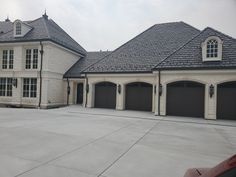 a large house with two garages and three windows